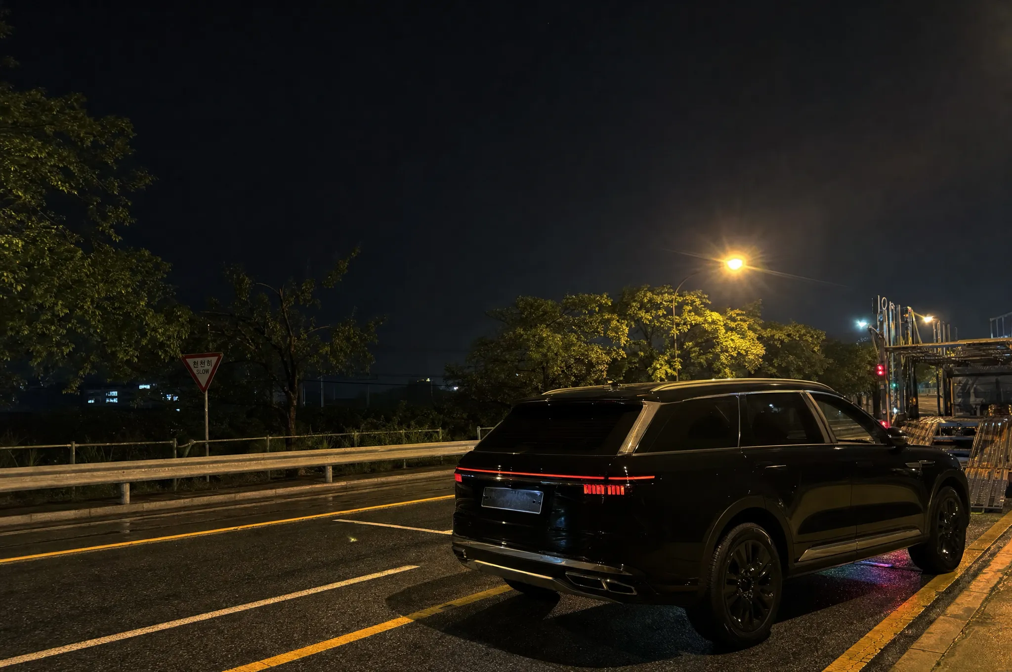 A premium car ready for export on a Korean street at night